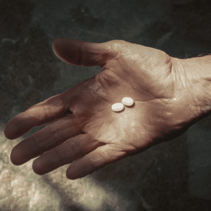 Medication in the hand of an older man. Elli Cares moble app Manage Medications for Seniors at Home