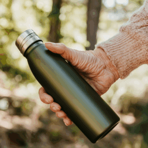 a water bottle being held by a hand. How to tell if you're drinking enough water