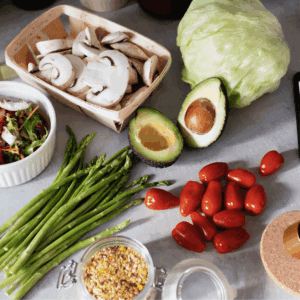 A selection of nutritious vegetables suitable for helping a parent eat healthier sitting on a white table.
